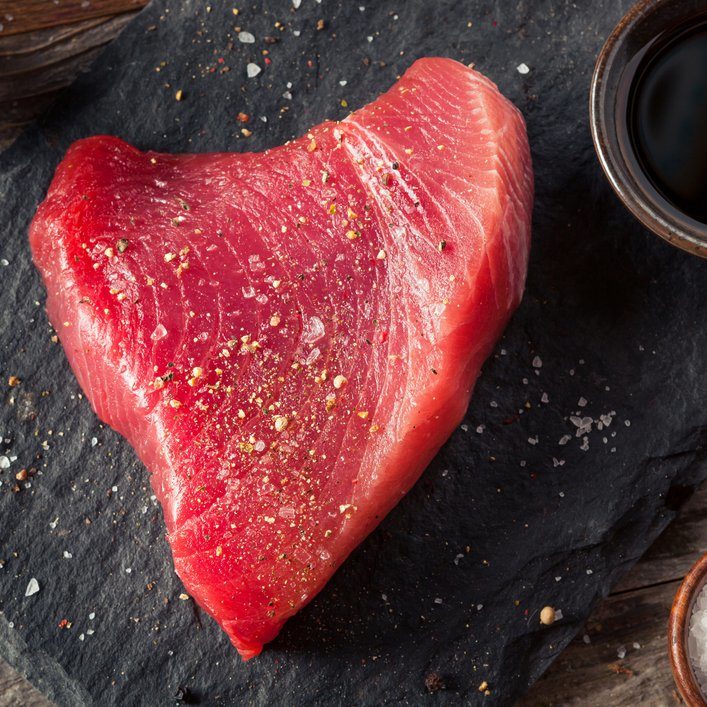 Raw Organic Pink Tuna Steak with Salt and Pepper